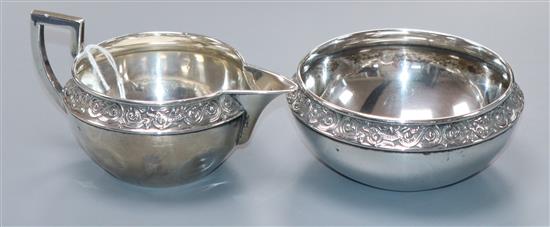 A Norwegian 830s white metal cream jug and sugar bowl by Thone.